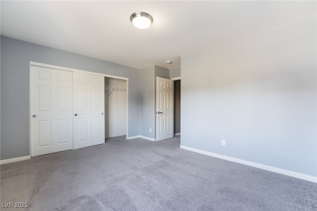 unfurnished bedroom featuring light colored carpet and a closet