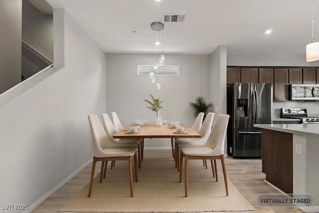 dining space with light hardwood / wood-style flooring