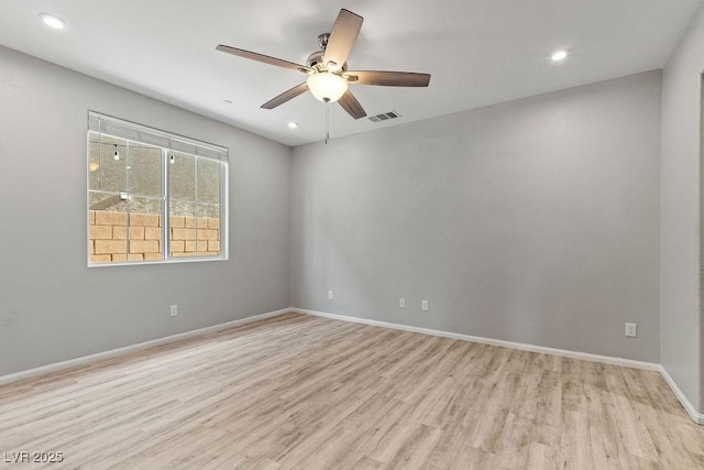 spare room with ceiling fan and light hardwood / wood-style flooring