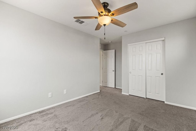 unfurnished bedroom with carpet floors, a closet, and ceiling fan