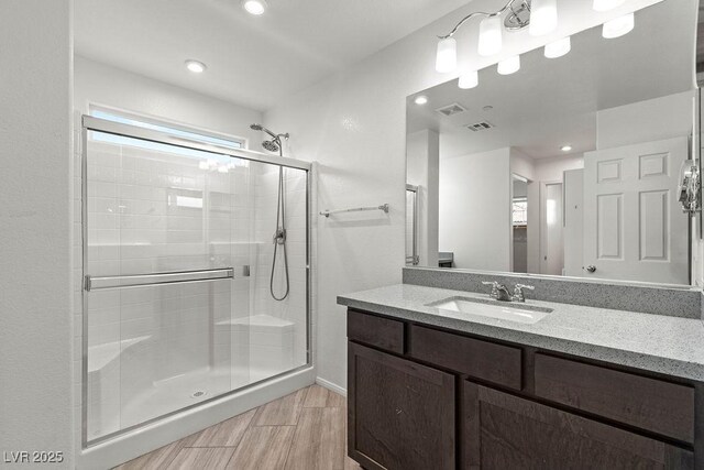 bathroom featuring vanity and an enclosed shower