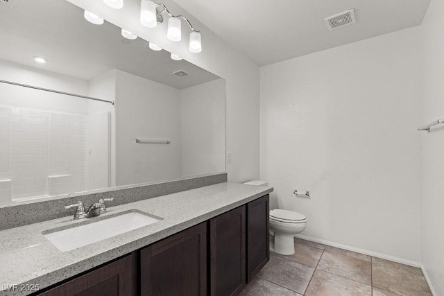 bathroom with a shower, tile patterned floors, vanity, and toilet