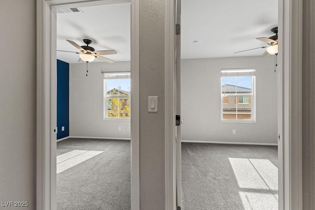 unfurnished room with ceiling fan and carpet floors