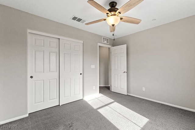 unfurnished bedroom featuring ceiling fan, a closet, and carpet