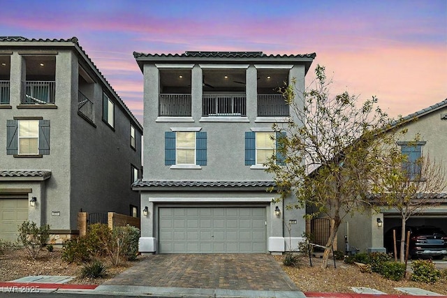 mediterranean / spanish-style house with a garage