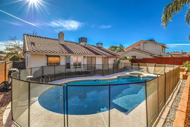 view of swimming pool with cooling unit and an in ground hot tub