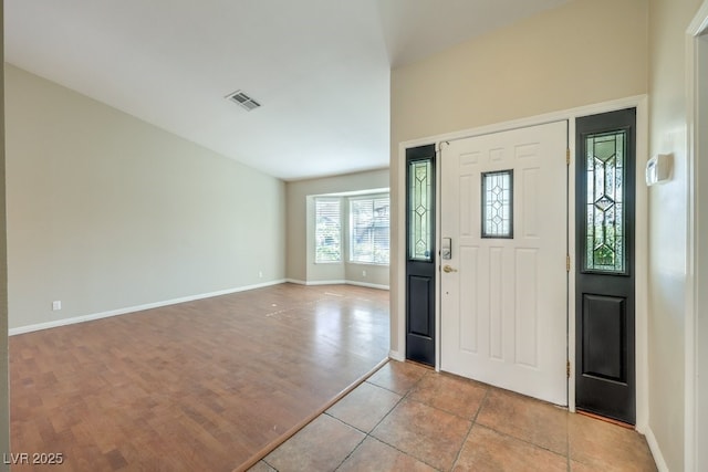 foyer entrance with light tile patterned floors