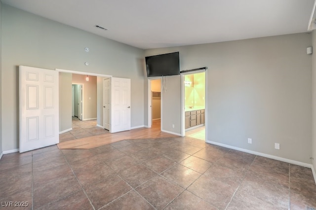 unfurnished room featuring lofted ceiling