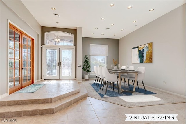 dining room featuring a chandelier, french doors, and light tile patterned floors