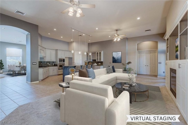 tiled living room with ceiling fan