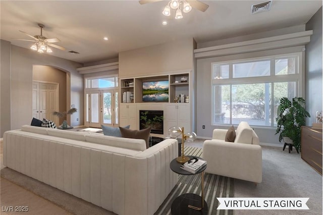 carpeted living room featuring ceiling fan