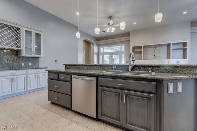 kitchen featuring backsplash, stainless steel dishwasher, ceiling fan, sink, and white cabinets