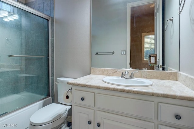 full bathroom with shower / bath combination with glass door, vanity, and toilet