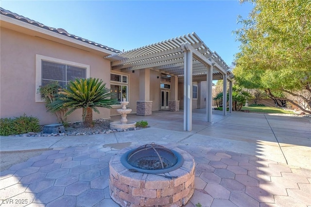 view of patio / terrace featuring a pergola and an outdoor fire pit