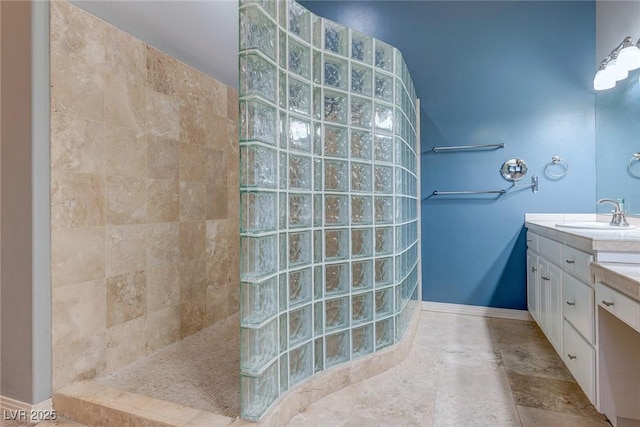 bathroom with vanity and a tile shower