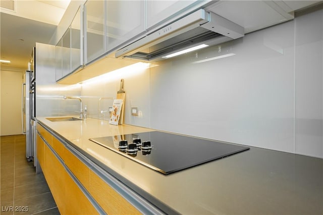 kitchen featuring black electric cooktop, sink, and extractor fan