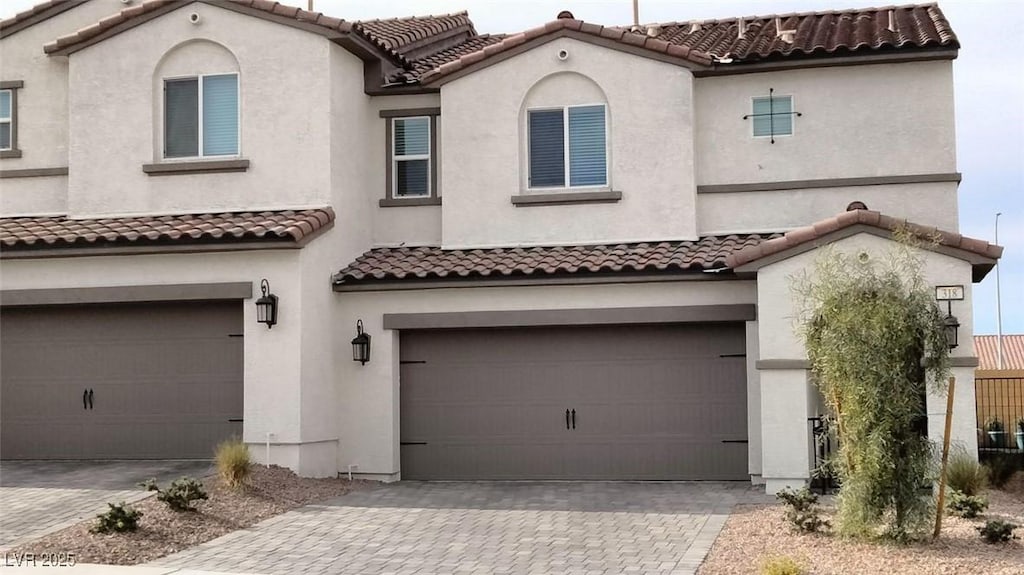 mediterranean / spanish house with a garage