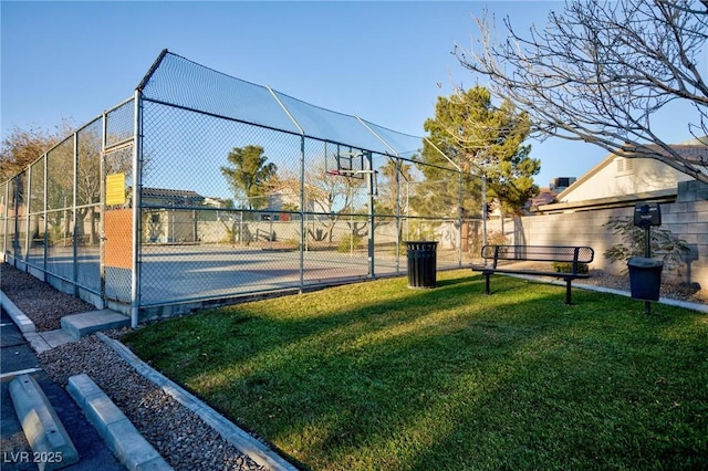 view of sport court featuring a yard