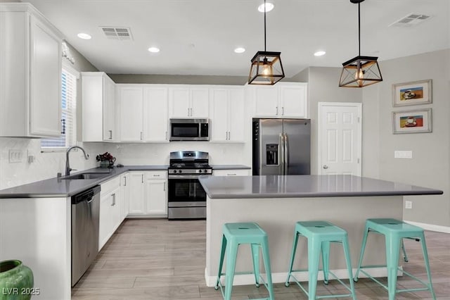 kitchen with white cabinetry, sink, and appliances with stainless steel finishes