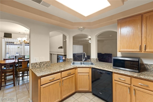 kitchen featuring kitchen peninsula, ceiling fan, sink, light tile patterned floors, and black dishwasher