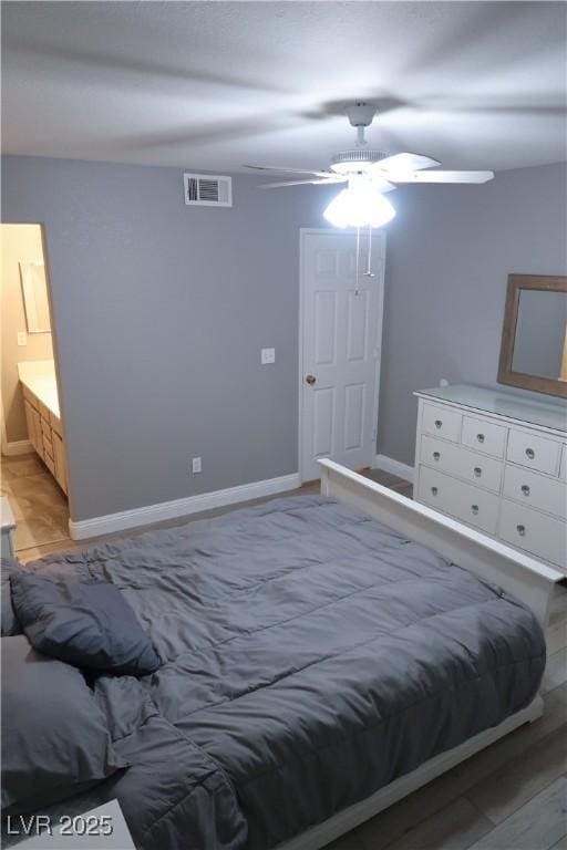 bedroom with ensuite bathroom, ceiling fan, and light hardwood / wood-style floors