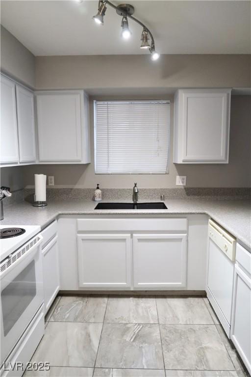 kitchen featuring white cabinetry, white appliances, and sink