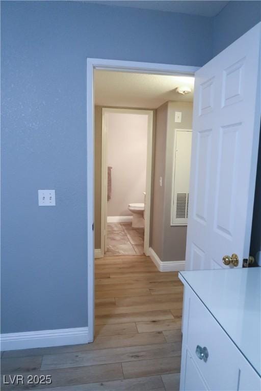 hallway with light hardwood / wood-style flooring