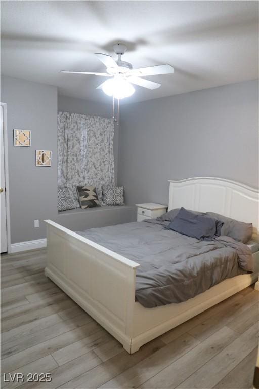 bedroom with light wood-type flooring and ceiling fan