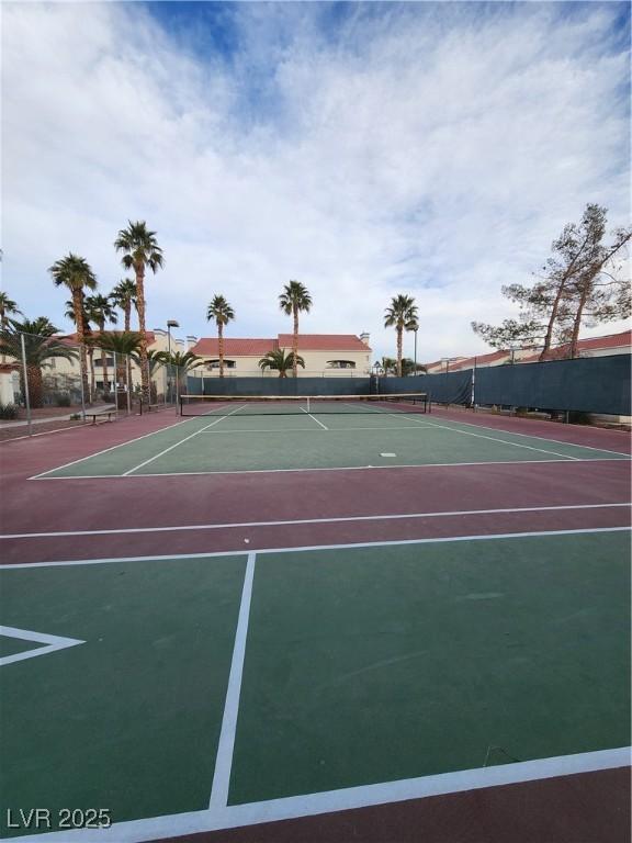 view of tennis court with basketball hoop