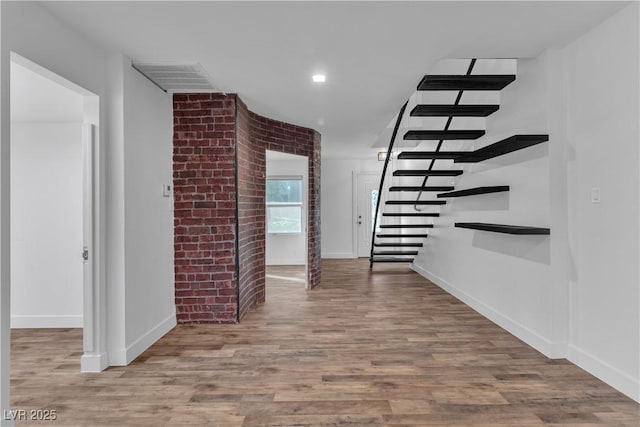 corridor with hardwood / wood-style flooring