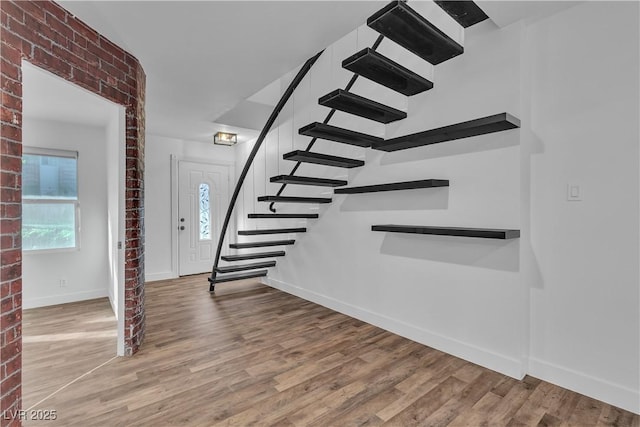 staircase with hardwood / wood-style floors