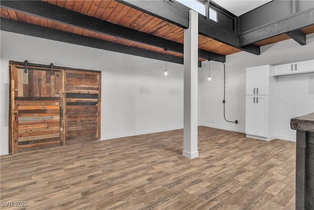 basement with hardwood / wood-style floors, a barn door, and wood ceiling