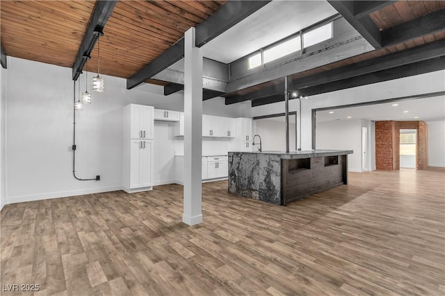 basement featuring light hardwood / wood-style floors, a healthy amount of sunlight, and wooden ceiling