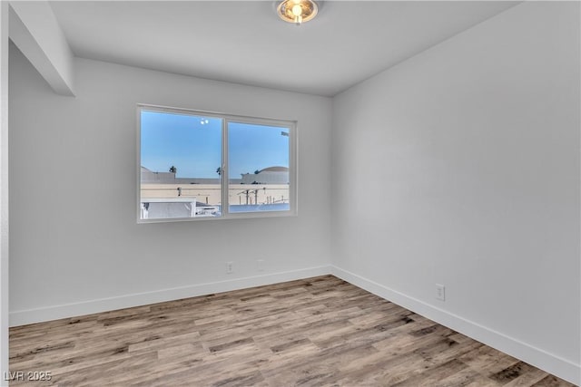 empty room with light hardwood / wood-style flooring