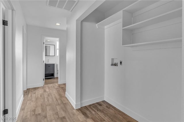 laundry room featuring light hardwood / wood-style flooring