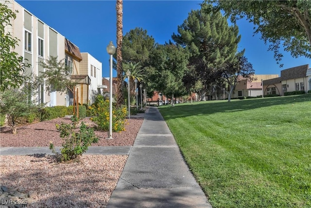 view of property's community with a lawn