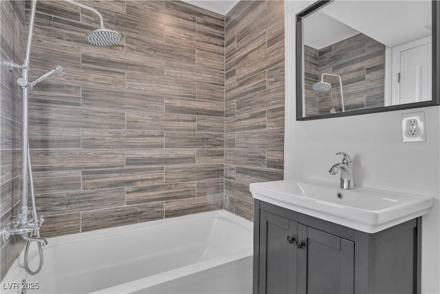 bathroom featuring vanity and tiled shower / bath