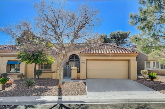 view of front of property with stucco siding, a tiled roof, and a garage