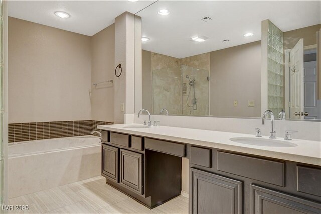 bathroom with vanity, shower with separate bathtub, and tile patterned flooring