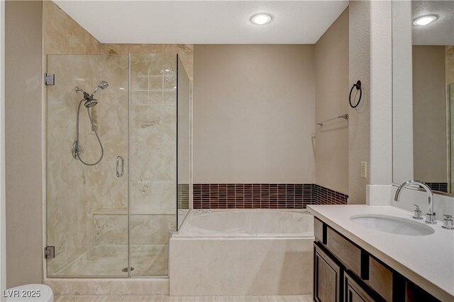 bathroom with vanity and independent shower and bath