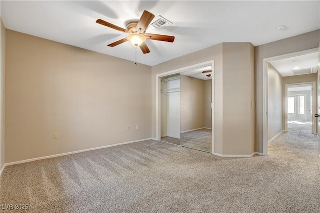 unfurnished bedroom with light colored carpet, a closet, and ceiling fan