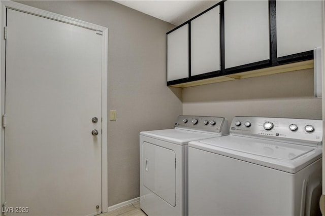 washroom featuring independent washer and dryer and cabinets