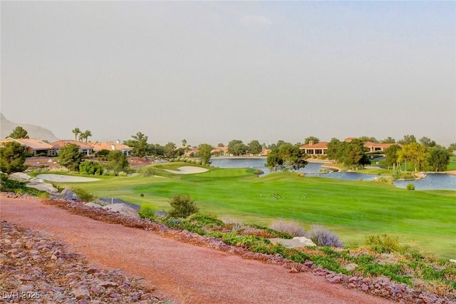 surrounding community featuring a water view and a yard