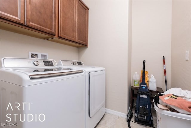 laundry area featuring cabinets, light tile patterned flooring, and washing machine and clothes dryer