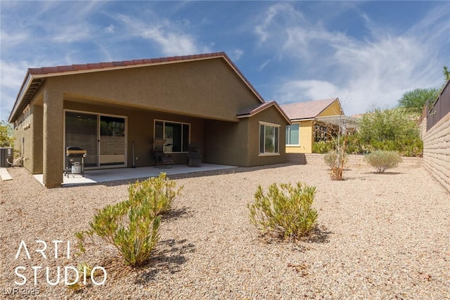 rear view of house with a patio area and central air condition unit