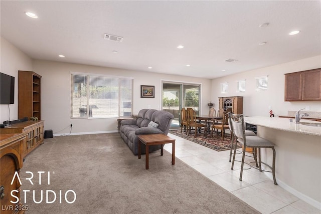 living room with light tile patterned flooring and sink