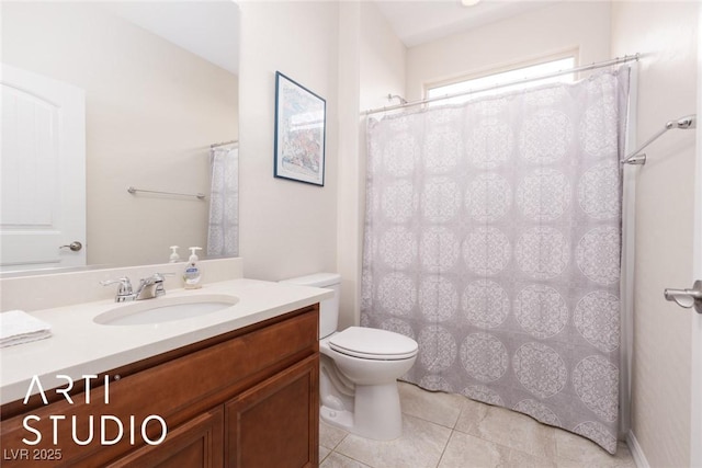 bathroom featuring toilet, vanity, and tile patterned floors