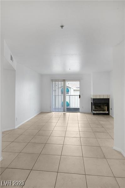 unfurnished living room with light tile patterned floors