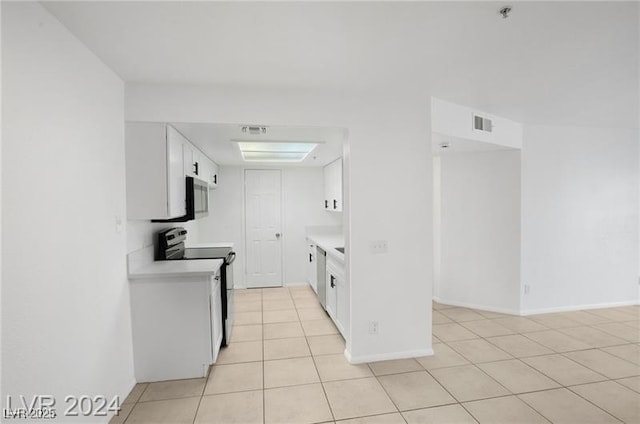 kitchen with range with electric stovetop, white cabinetry, and light tile patterned floors