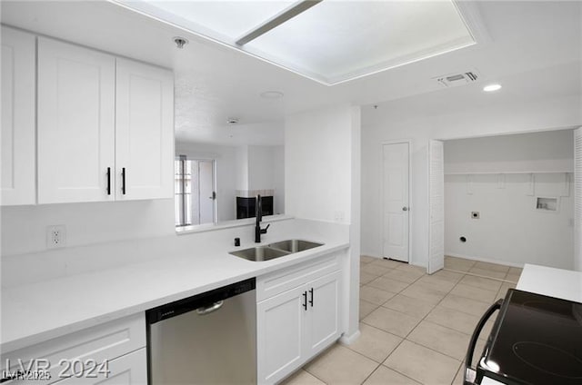 kitchen with stove, stainless steel dishwasher, sink, light tile patterned floors, and white cabinets